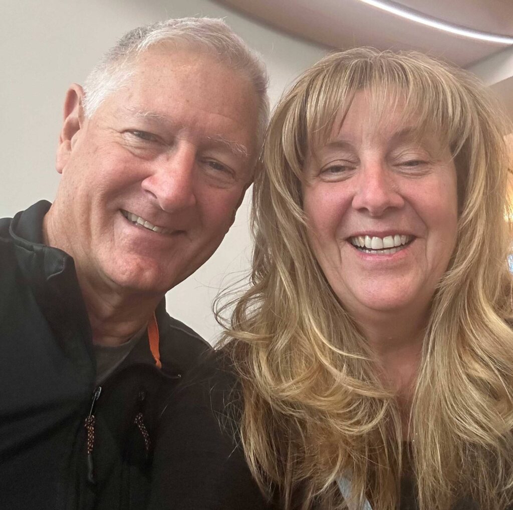 Smiling middle-aged couple taking indoor selfie